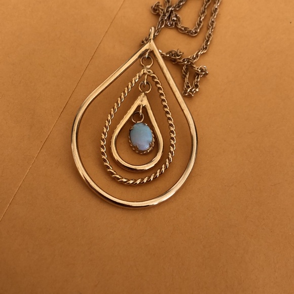 Vintage Opal like free moving oval stone, 3 free moving oval gold colored hoops. - Picture 8 of 9